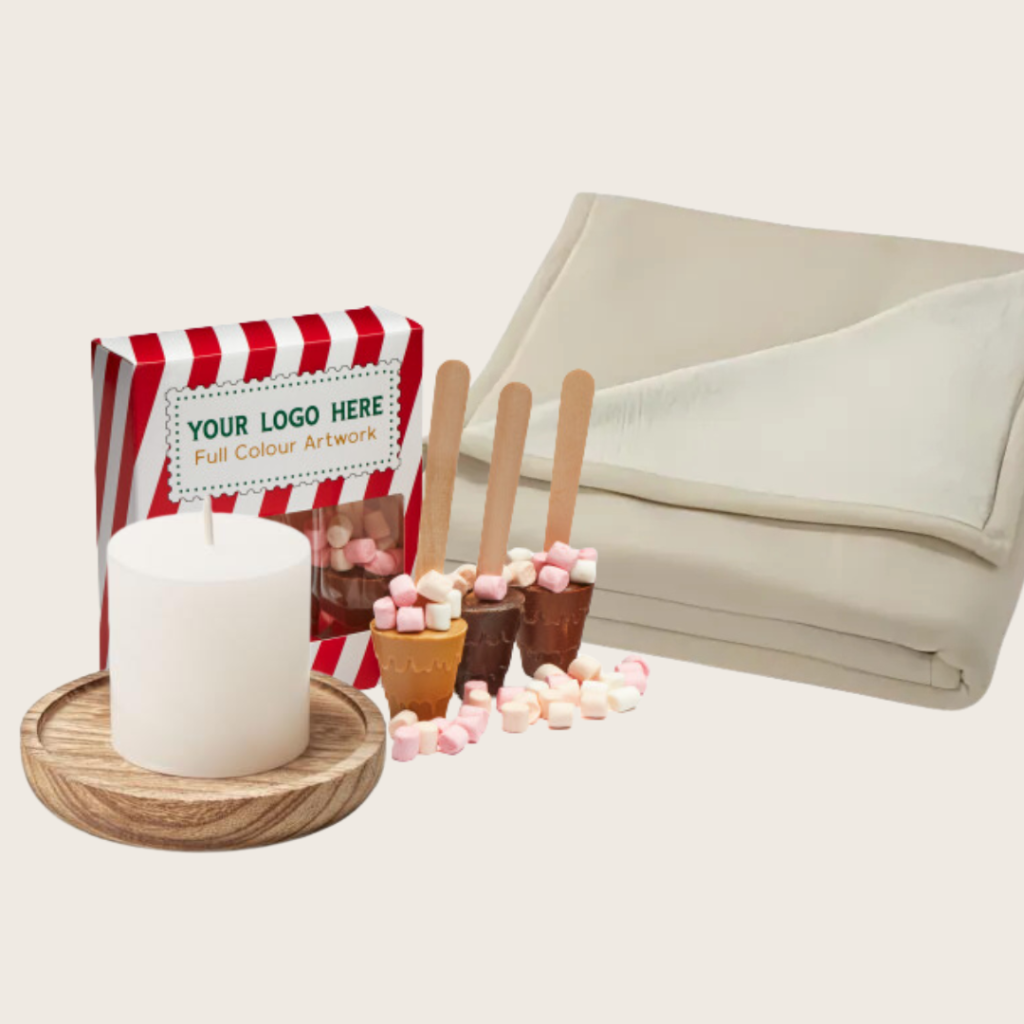 Branded options on a blanket, hot chocolate and a candle.