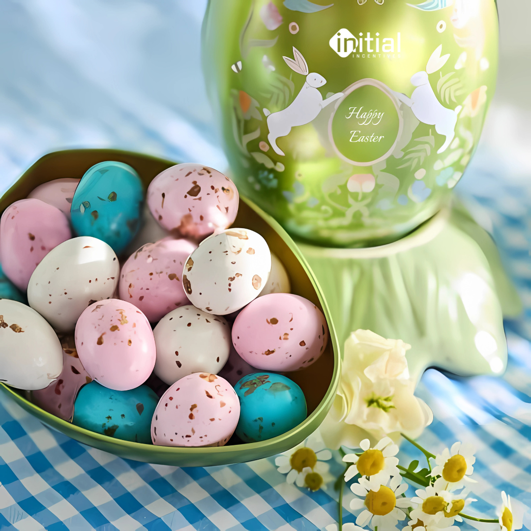 A chocolate easter egg with many mini eggs sitting inside whilst sat on a table in the sunlight.