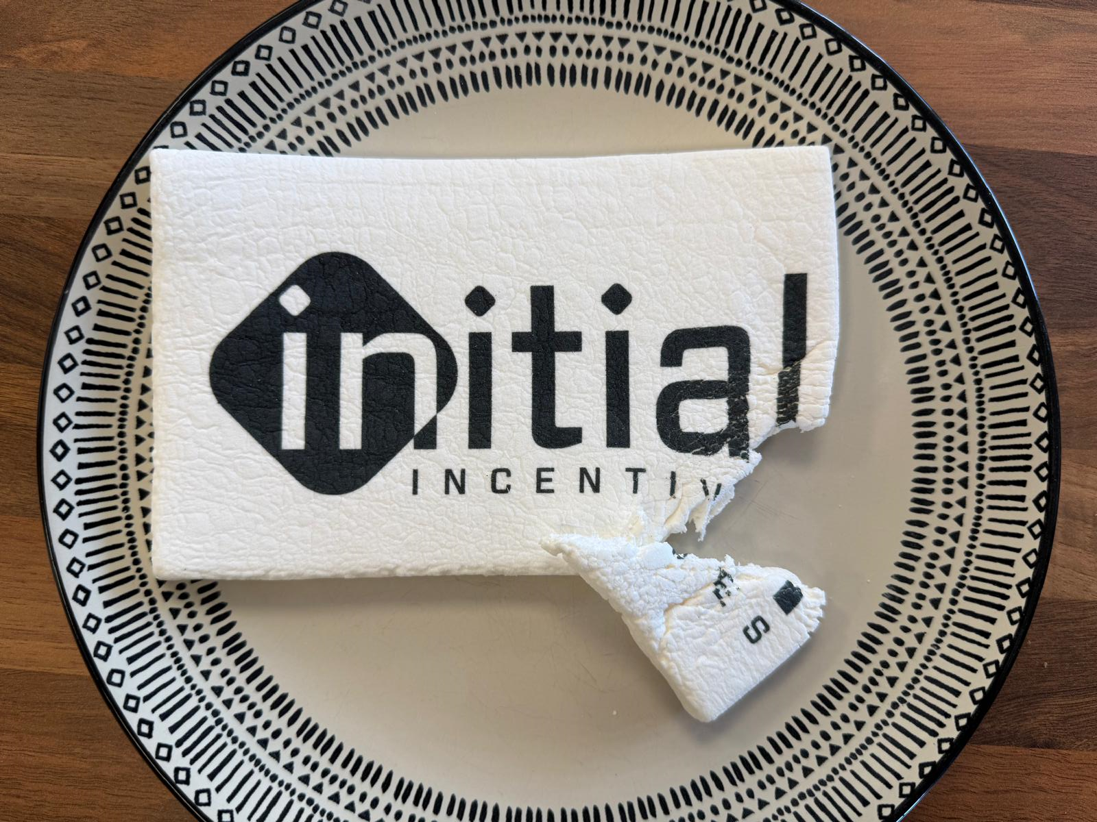 A marshmallow that has had a corner bitten out of it, branded with our company logo.