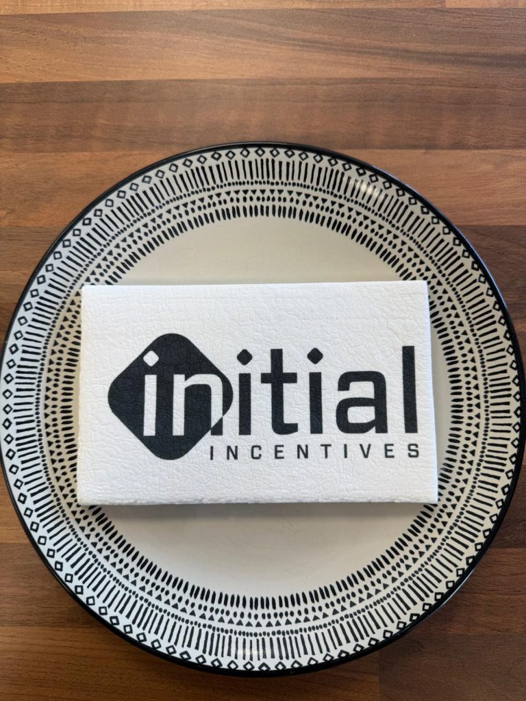 A custom printed marshmallow on a plate to highlight its size and detailed logo design more clearly.