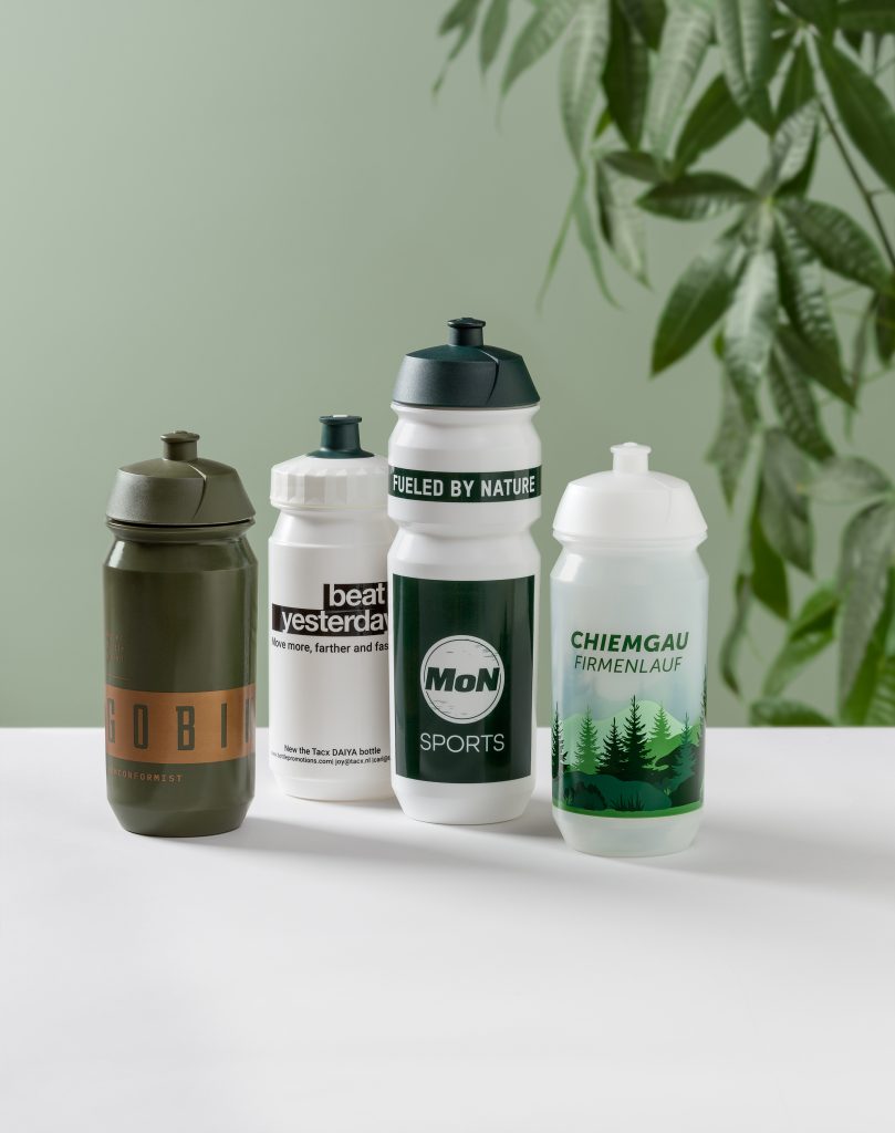Branded sports bottles with custom logo placed on an office desk.
