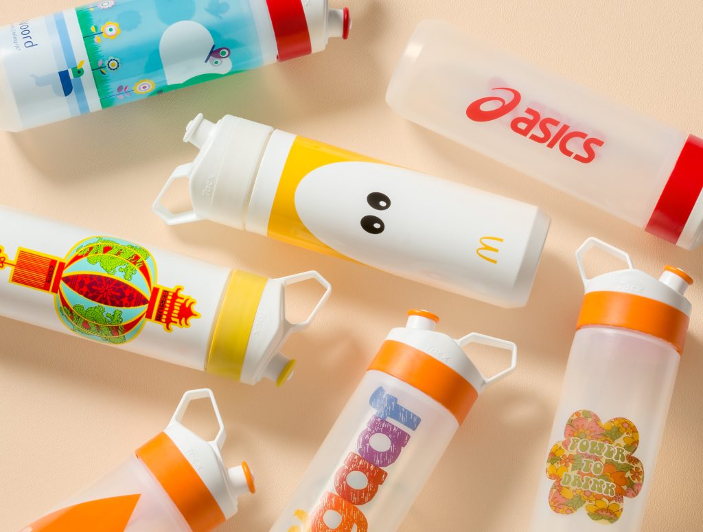 Branded water bottles with custom full colour print logos to help with brand visibility, all laid out on a cream background.