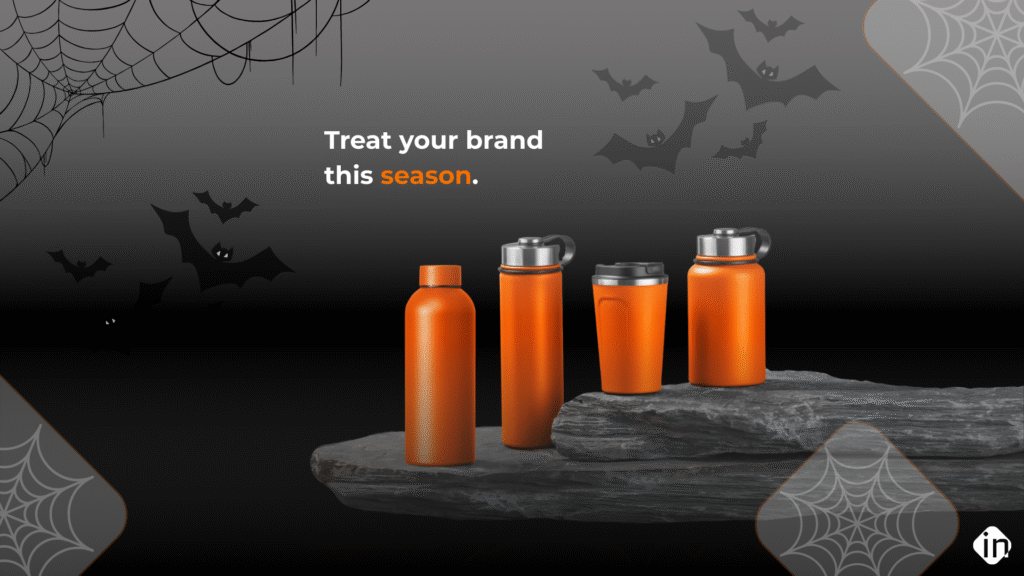 Halloween-themed promotional image featuring orange branded drinkware bottles and tumblers displayed on stone with bats and spider webs in the background.