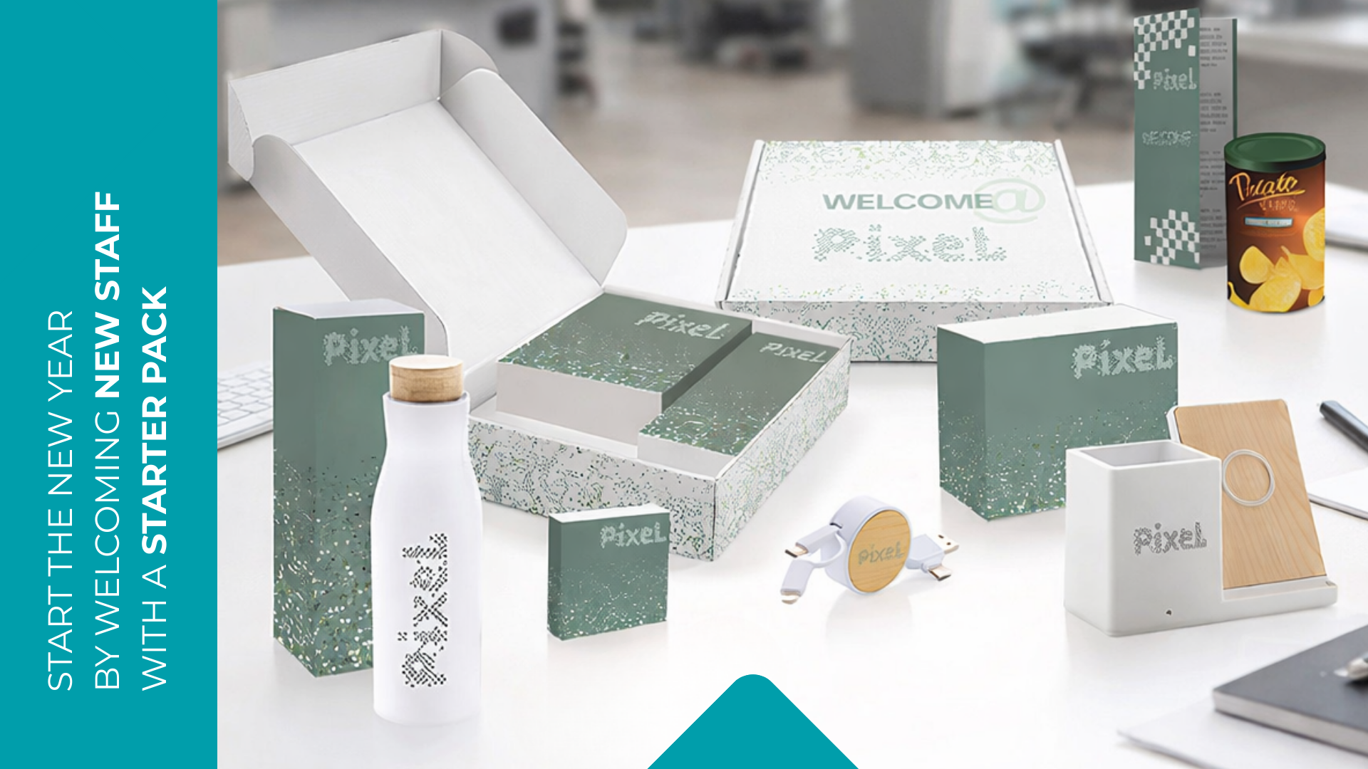 Branded New Year staff pack presented in a custom gift box containing a notebook, speaker and printed materials, displayed on a desk.