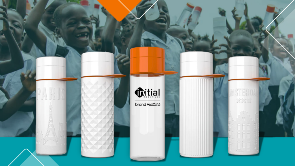 Reusable Join the Pipe water bottles with custom branding, shown in front of children celebrating clean water projects.